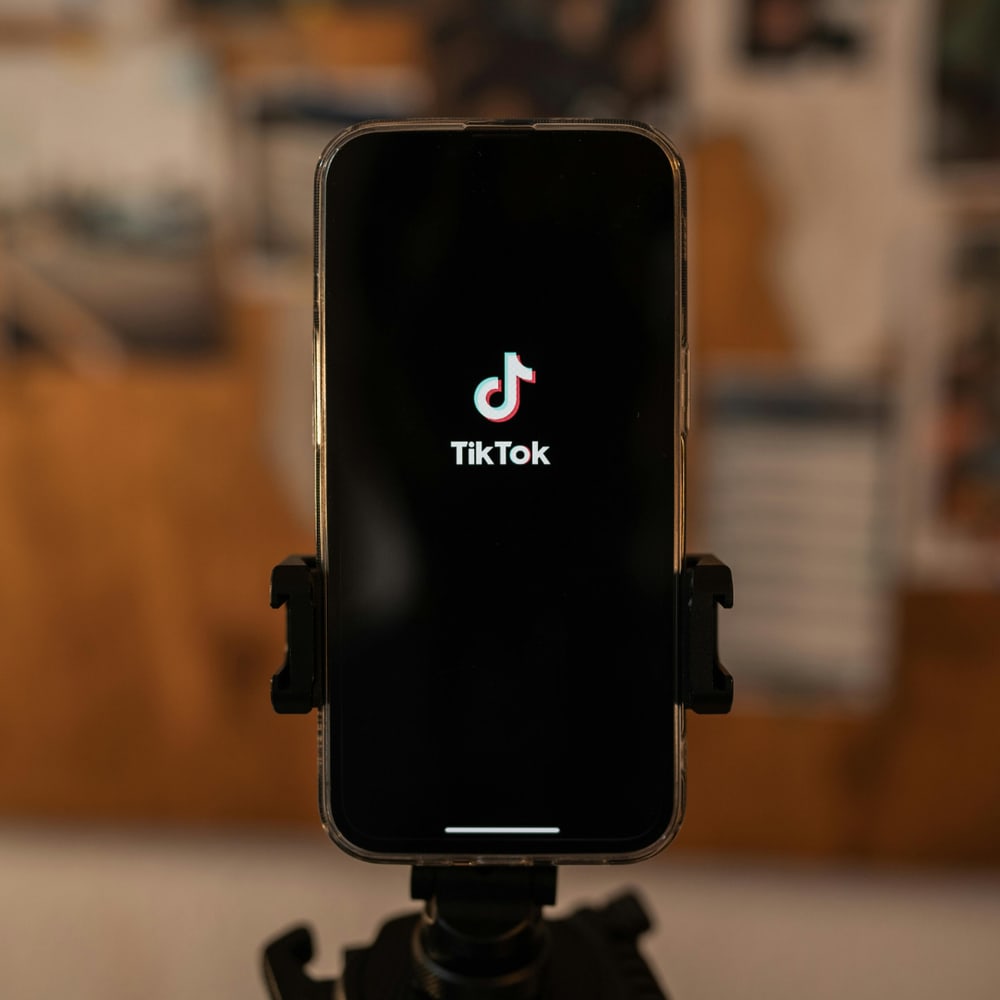 Phone showing TikTok app on tripod